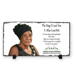 Memorial plaque with a portrait of a woman and a quote on a white background