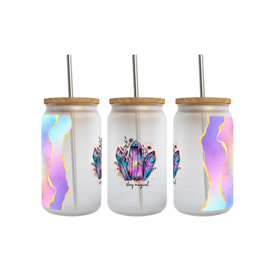 A set of three frosted glass tumblers with a 'Stay Magical' design, featuring colorful patterns and a crystal illustration, each with a stainless steel straw.